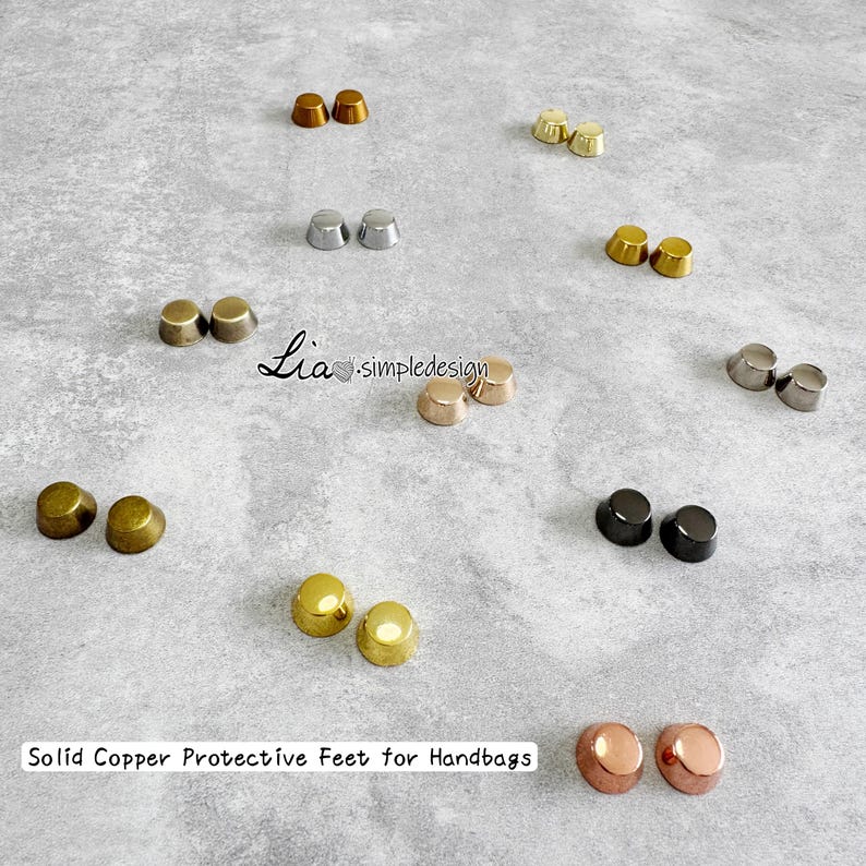 May include: A selection of solid copper protective feet for handbags in diverse metallic finishes, such as gold, silver, bronze, and black. The feet are dome-shaped, designed to safeguard handbag bases. The text "Solid Copper Protective Feet for Handbags" is visible.