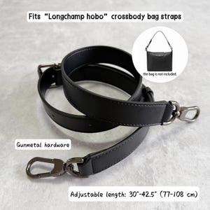 May include: A black leather crossbody bag strap with gunmetal hardware. The strap is adjustable from 30 to 42.5 inches. Text on the image reads: Fits "Longchamp hobo" crossbody bag straps, Gunmetal hardware, Adjustable length: 30"-42.5" (77-108 cm).