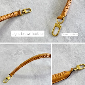 May include: Light brown leather strap with a plaited design and old gold hardware. The strap has a hook on each end. The text "Light brown leather" and "Old gold hardware" are visible in the image.