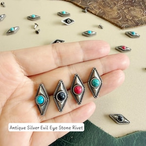 May include: Antique silver-toned metal rivets in a diamond shape, each featuring a central round stone in turquoise, black, or red. The rivets have a textured border and are labelled as Antique Silver Evil Eye Stone Rivet in the image.