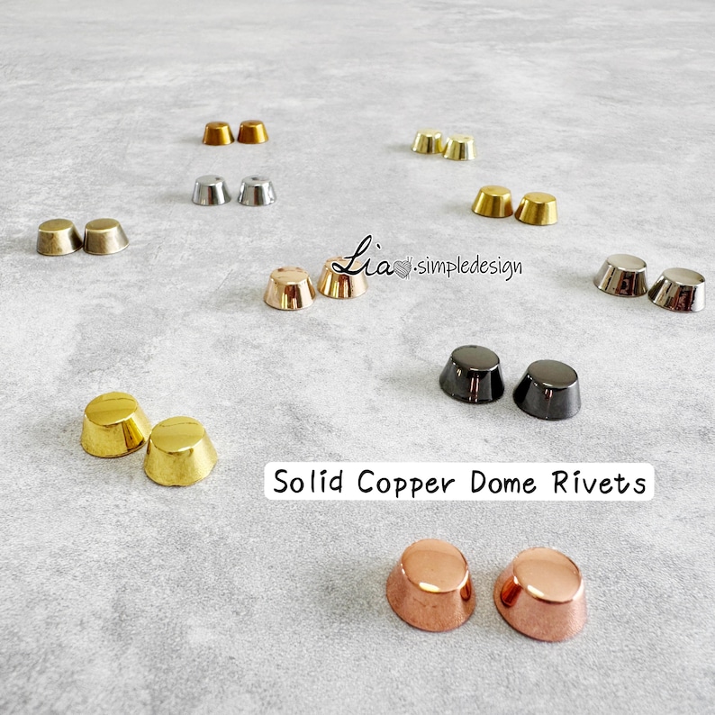 May include: A selection of solid copper dome rivets in gold, silver, and copper finishes. The rivets are displayed on a light grey surface. Text reads "Solid Copper Dome Rivets".