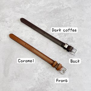 May include: Two thin leather watch straps with silver-toned metal buckles. One strap is dark coffee brown labeled "Dark coffee" and "Back," while the other is a lighter caramel brown labeled "Caramel" and "Front," featuring visible stitching.