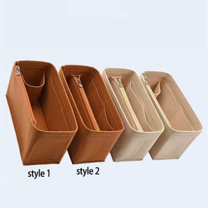 Puede incluir: Cuatro organizadores de bolsos de fieltro en tonos marrón y beige. Cada organizador tiene forma rectangular con un compartimento principal con cremallera y bolsillos adicionales. El texto "style 1" y "style 2" es visible en la parte inferior.