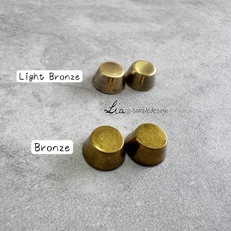 May include: Two sets of bronze-coloured thimble-shaped objects. One set is labelled "Light Bronze" and the other "Bronze". The text "Lia simpledesign" is also visible. The objects are on a grey surface.