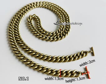 May include: Gold chain necklace with a curb link design. The chain is 1.3 cm wide and 1.3 cm high. The chain has a T-bar clasp. NO. 1