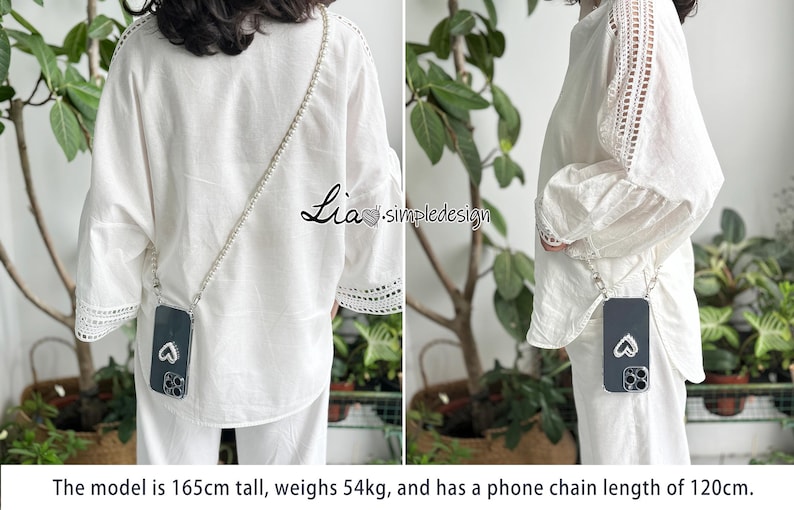 May include: A phone case with a silver chain worn across the body. The black phone case has a heart design. The model is wearing a white blouse and pants. The text "Lia simpledesign" is visible.