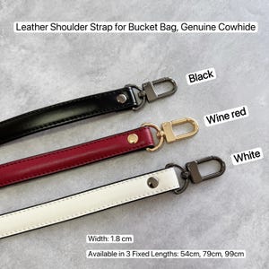 May include: Leather shoulder straps for bucket bags in black, wine red, and white. The straps are made of genuine cowhide and are 1.8 cm wide. Available in 3 fixed lengths: 54cm, 79cm, and 99cm.