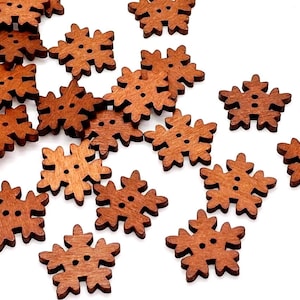 May include: A collection of brown wooden buttons shaped like six-pointed snowflakes. Each button features a smooth finish and two small holes in the center for attachment. The buttons are scattered across the frame in various orientations.