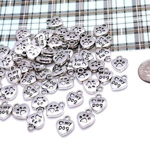 May include: A large quantity of silver-toned metal charms in the shape of a heart with the words "My Dog" and a paw print.