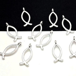 May include: A collection of ten silver-toned metal charms shaped like fish. The charms have a simple, open design and are perfect for adding a touch of faith to jewelry projects.