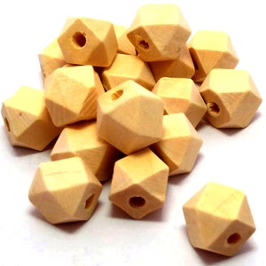 May include: A pile of light brown wooden beads with a faceted, geometric shape. Each bead has a hole drilled through the center for stringing.