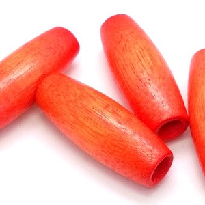 May include: Four bright orange wooden beads, each with a smooth, oval shape. The beads are made of natural wood and have a slightly textured surface.