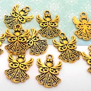 May include: Ten gold-colored angel charms with intricate details. Each charm features a stylized angel with wings and a halo. The charms are perfect for adding a touch of elegance to jewelry, crafts, or home decor.