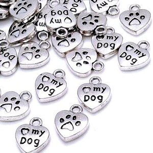 May include: Silver heart-shaped charms with the words "my dog" and a paw print design.