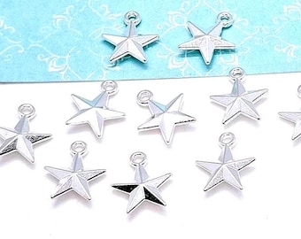 May include: A collection of silver-colored star charms with a loop at the top for attaching to jewelry or other crafts. The charms are arranged on a white surface with a light blue patterned background.
