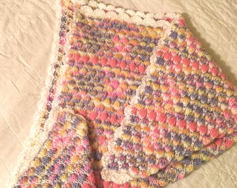 Knitted baby blanket for a girl .