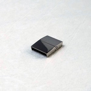 May include: A silver magnetic clasp for jewellery making. The clasp is rectangular and has a smooth, polished finish.