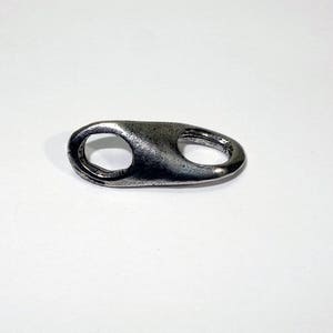May include: A silver metal key chain with a simple oval loop.
