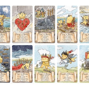 May include: A set of fourteen tarot cards featuring yellow horned creatures in various scenes. Each card includes a title like Ace of Swords through King of Swords, a scroll-shaped text box with descriptive text, and watercolour-style illustrations.