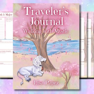 May include: A softcover journal titled Traveler's Journal Walking with Mystic by Lisa Papez. The cover features a white unicorn resting under a tree near a blue stream, set against a pink landscape. Interior pages show structured planning layouts.