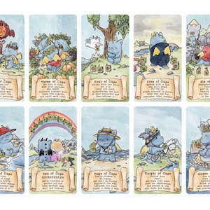 May include: A collection of fourteen tarot cards featuring blue dragon-like creatures in various scenes. Each card includes a title, such as Ace of Cups through King of Cups, and a short text passage printed on a scroll graphic at the bottom of each card.