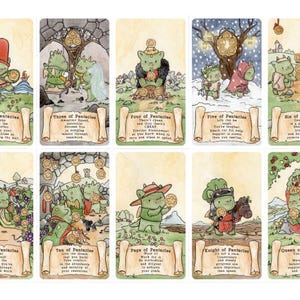 May include: A set of fourteen tarot cards featuring green dragon characters in various scenes. Each card displays a title like Ace of Pentacles or King of Pentacles, accompanied by descriptive text on a scroll graphic at the bottom of each card.