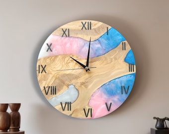 May include: A round wooden clock with Roman numeral markings and a blue, pink, and white resin design. The clock has black hands.