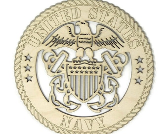 May include: A wooden cutout of the United States Navy seal. The seal features an eagle with outstretched wings, a shield with stars and stripes, and two anchors. The words "United States Navy" are inscribed around the seal.