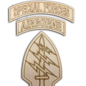 May include: A wooden cutout of the Special Forces Airborne insignia. The insignia features a green beret with the words "Special Forces" and "Airborne" on it. The insignia is surrounded by a black outline.