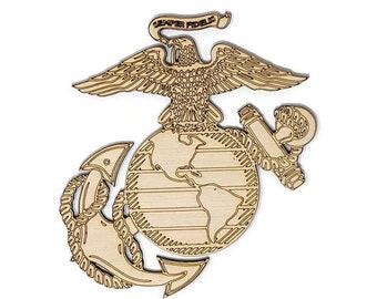 May include: Wooden emblem featuring the United States Marine Corps insignia. The design includes an eagle perched atop a globe, an anchor, and a banner with the text "Semper Fidelis". The emblem is made of light-colored wood.