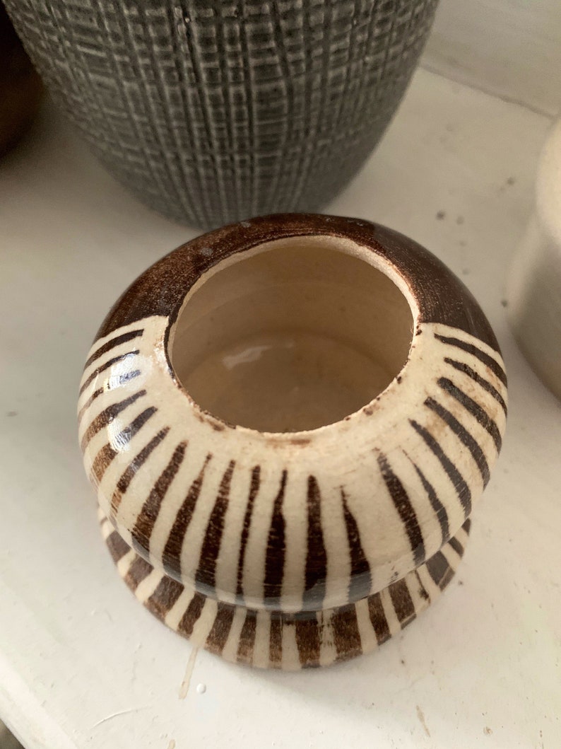 Small hand thrown stonewear ceramic vase in chocolate brown and striped pattern