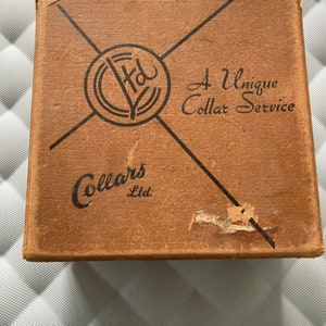 Box containing 11 collars and 2 bowties. c1950s