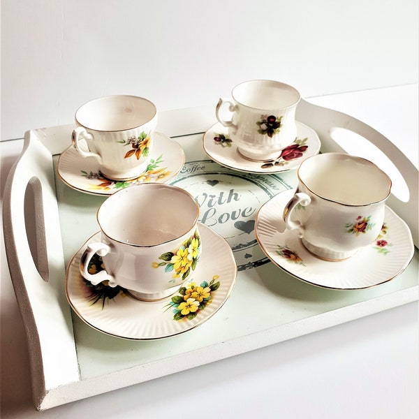 An elegant lot of FIVE  bone china tea set, teacup and saucer, High-quality bone china made in England and bric and brac serving tray.