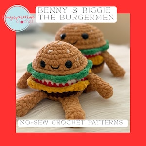 May include: Two crocheted burger plushies, "Benny & Biggie the Burgermen", with brown buns, green lettuce, yellow cheese, and red tomato layers. The plushies have smiling faces and attached limbs. The image includes the text "No-Sew Crochet Patterns".