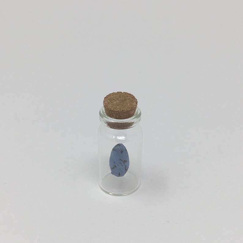 little handmade eggs hanging in small glass bottles