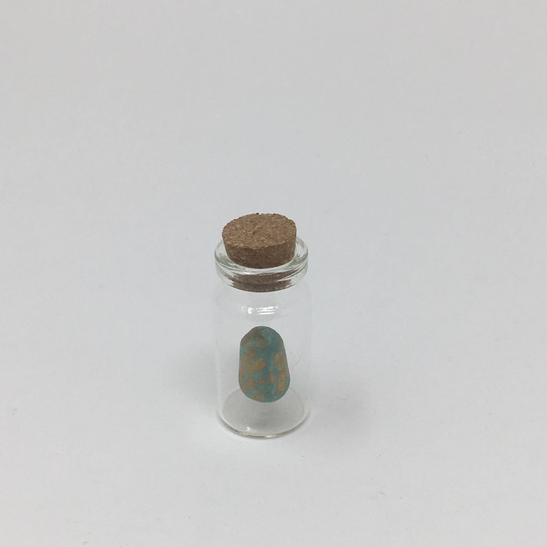 little handmade eggs hanging in small glass bottles