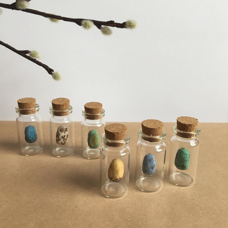 little handmade eggs hanging in small glass bottles