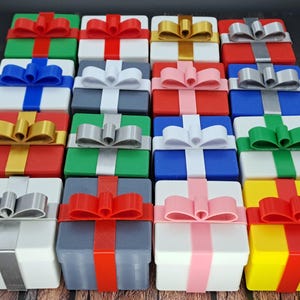 Sixteen gift card gift boxes shown in a variety of box colors and ribbon colors.