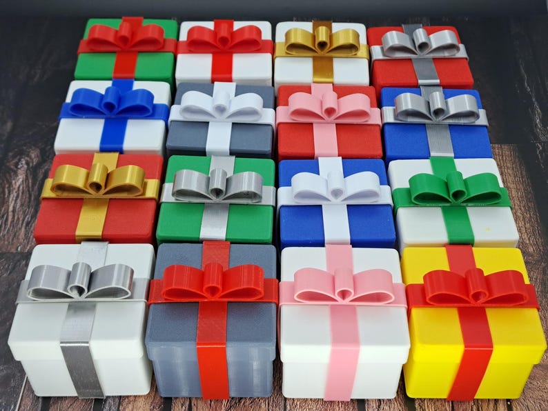 Sixteen gift card gift boxes shown in a variety of box colors and ribbon colors.