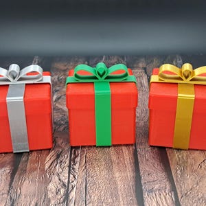 gift card holder boxes are shown in red with silver, green and gold ribbons