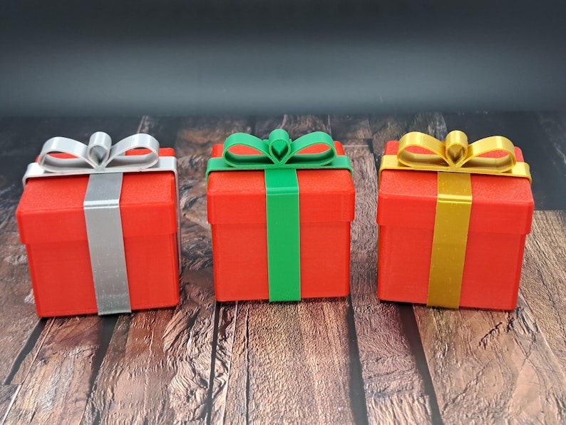 gift card holder boxes are shown in red with silver, green and gold ribbons