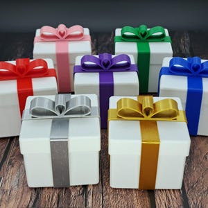 gift card holder boxes are shown in white with silver, green, red, blue, purple, pink and gold ribbons