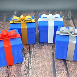gift card holder boxes are shown in blue with red, gold, white and silver ribbons