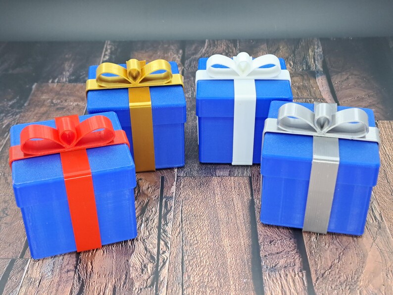 gift card holder boxes are shown in blue with red, gold, white and silver ribbons