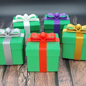 gift card holder boxes shown in green with silver, red, gold, white and purple ribbons