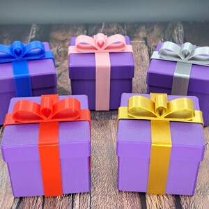gift card gift box shown in purple with blue, red, pink, gold and silver ribbons