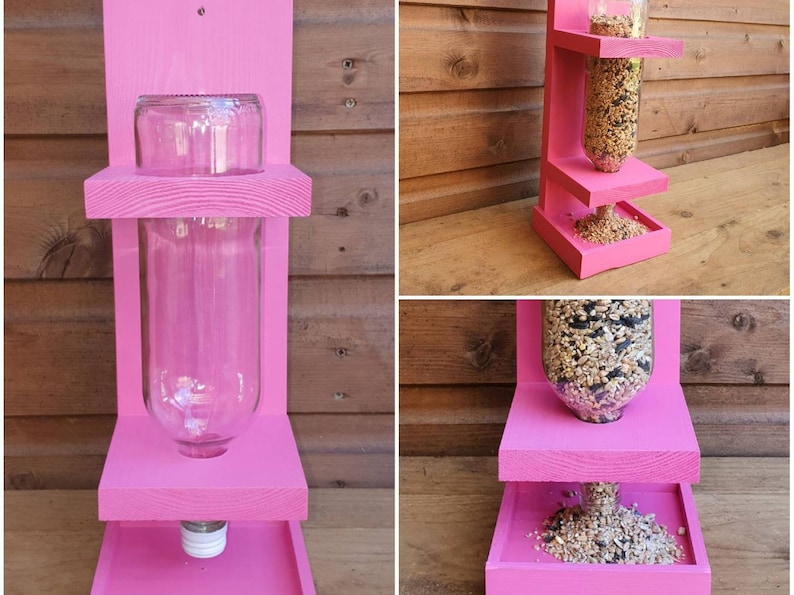 May include: Pink wooden bird feeder with a clear plastic bottle for holding birdseed. The feeder has three shelves and a small tray at the bottom.