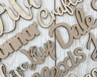May include: A collection of wooden words, including "Love", "Alexia", "Dale", "Grammar", and "Crafts". The words are cut out of wood and have a natural brown color.