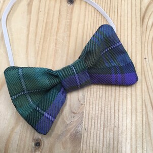 May include: A green and purple plaid bow tie with an elastic band.