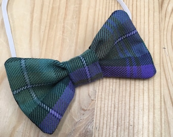 May include: A green and purple plaid bow tie with an elastic band.